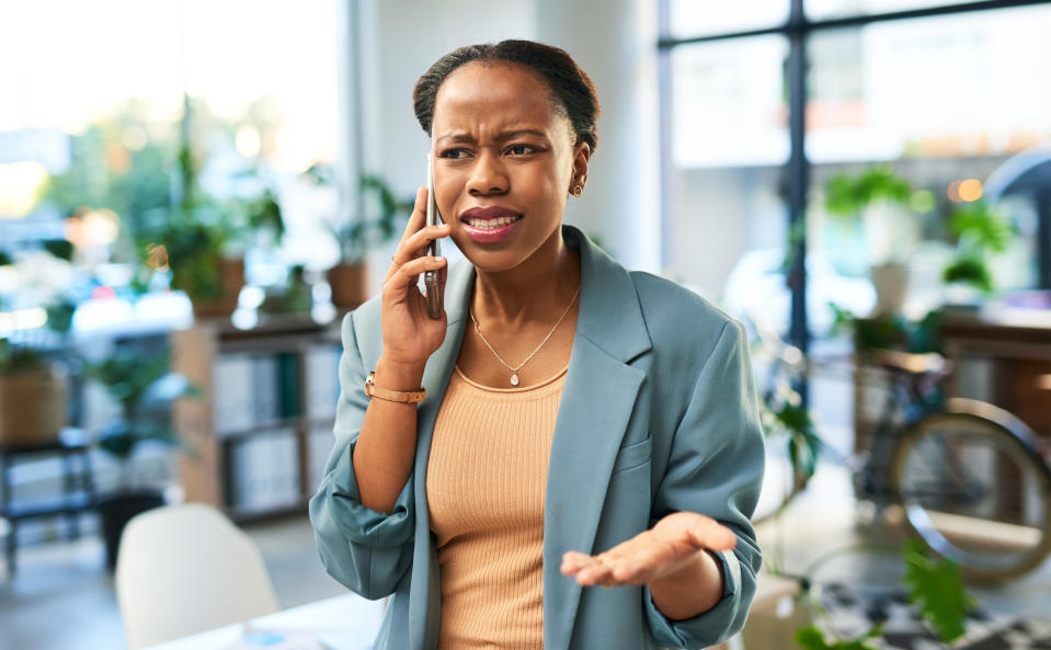 A woman looking confused while on the phone