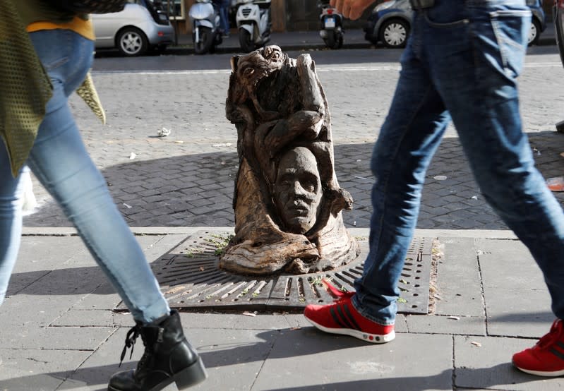 Andrea Gandini's sculputure from a dead tree stump is displayed in Rome