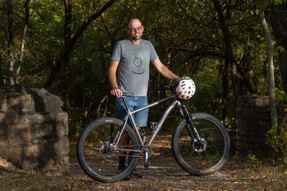 Andy Phillips poses with his single-speed hardtail mountain bike on the yellow trails at Dornwood Nature Trails earlier this month. For the past decade, Phillips has volunteered his time to maintain the trails and is now the trail coordinator through Top City Trails Alliance.