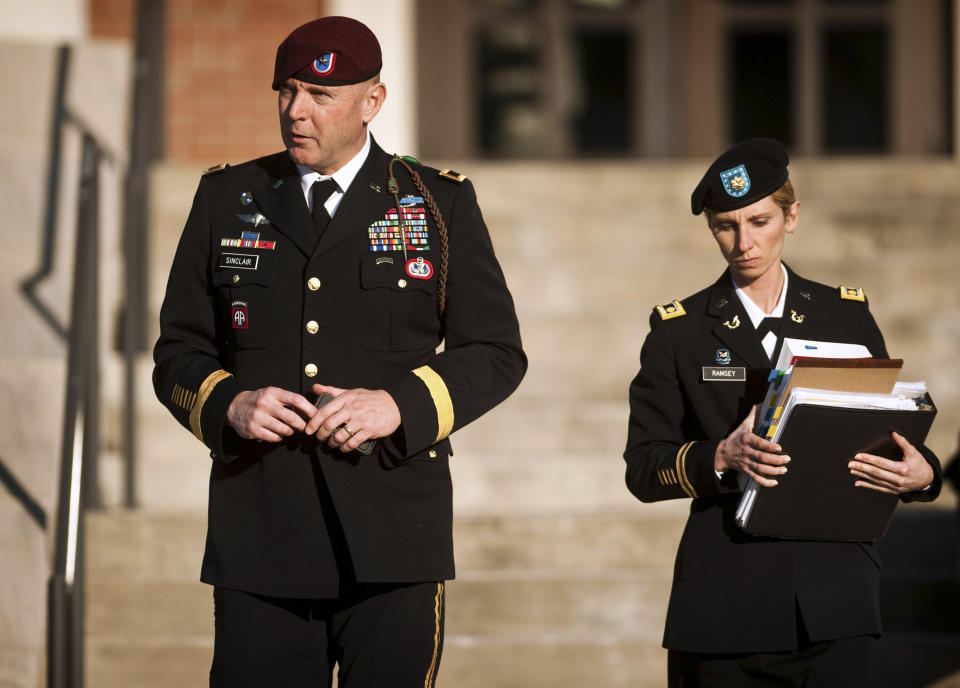 FILE - In this Tuesday, Jan. 22, 2012 file photo, Army Brig. Gen. Jeffrey A. Sinclair, left, leaves a Fort Bragg courthouse with a member of his defense team, Maj. Elizabeth Ramsey, after he deferred entering a plea at his arraignment on charges of fraud, forcible sodomy, coercion and inappropriate relationships. Sinclair is scheduled to appear Tuesday, March 4, 2014 in a Fort Bragg courtroom on criminal charges that include physically forcing a female captain under his command to perform oral sex. The 51-year-old married father admits he carried on a three-year extramarital affair with the junior officer, but denies any physical abuse. (AP Photo/The Fayetteville Observer, Andrew Craft, File)