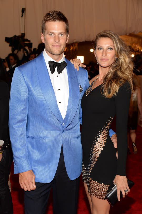 <p>Tom Brady in a blue tuxedo jacket with Gisele Bundchen in Anthony Vaccarello scored a touchdown in their edgy and elegant looks. (Photo: Getty Images) </p>