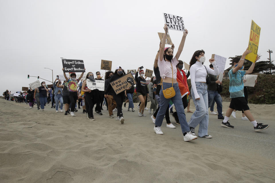 Gay activists and suppoters march on the Great Highway at Ocean Beach in San Francisco, Sunday, June 14, 2020, at a protest over the Memorial Day death of George Floyd, who died after being restrained by Minneapolis police. (AP Photo/Jeff Chiu)