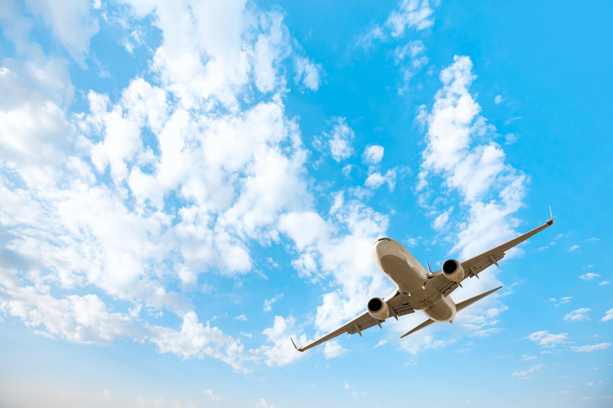 White passenger airplane flying in the sky.