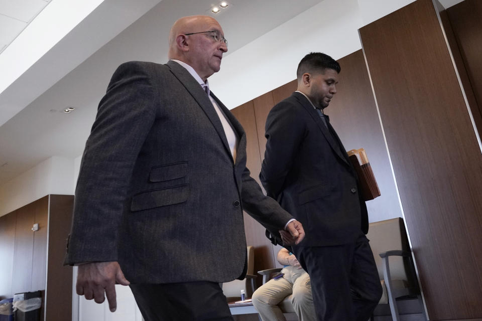 Robert E. Crimo Jr., right, and his attorney George Gomez, walk to the courtroom at the Lake County Courthouse, Friday, July 14, 2023, in Waukegan, Ill. Judge George D. Strickland on Friday set a Nov. 6 trial date for Crimo Jr. who is charged with helping his son obtain a gun license three years before the son allegedly shot dead seven people at a Fourth of July parade in suburban Chicago last year. (AP Photo/Nam Y. Huh, Pool)