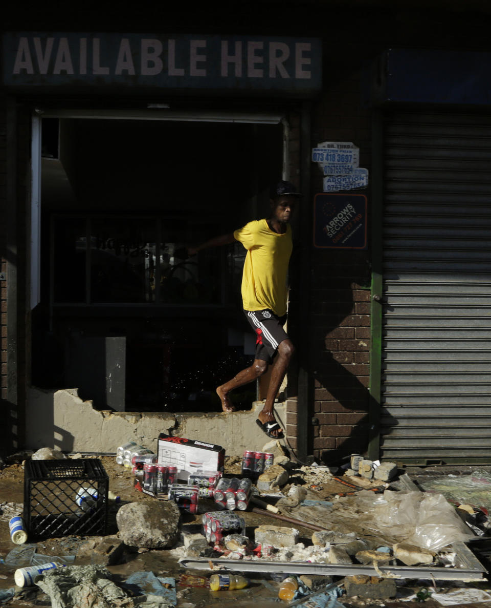 A man leaves a looted store in Germiston, east of Johannesburg, South Africa, Tuesday, Sept. 3, 2019. Police had earlier fired rubber bullets as they struggled to stop looters who targeted businesses as unrest broke out in several spots in and around the city. (AP Photo/Themba Hadebe)