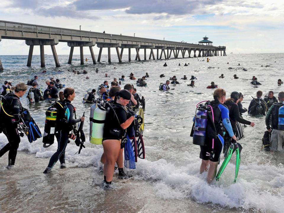 Over 600 scuba divers have set a world record for the largest mass subaquatic clean-up of a section of seabed.Equipped with aqualungs, a total of 633 divers simultaneously picked up litter from the sea floor near the Deerfield Beach International Fishing Pier in Florida.The record was overseen by Guinness officiator Michael Empric, who arrived from New York to do the official head count between 9am and 11am, the South Florida Sun Sentinel reports.“I actually stood there and clicked off everyone as they got in the water ... so we know immediately whether or not the record’s been broken,” he told the reporter, who described him as “sporting the dark blue Guinness blazer and teal tie in 87 degree heat (35C)”.Divers entered the ocean in groups and had to stay in the water for at least 15 minutes to count towards the record.Thirteen-year-old Dahlia Bolin travelled with her mother Rebecca all the way from Mackinaw, Illinois, to help set the record and pick up debris.She recovered a white, metal sign with red lettering warning: “Boats Must Not Come Within 100 Yards of Pier.”She told the paper: “It was at the end of the pier about 20 feet down, just kind of buried in the sand. There’s a lot of heavy weights for fishing line down there, but there’s some really beautiful fish, mostly.”The amount of rubbish collected has not yet been measured, but according to the paper the divers retrieved 1,600 pounds (725kg) of lead fishing weights alone, the result of years of anglers cutting their lines free.The previous record for the most divers taking part in an underwater cleanup was 614, in a dive organised by Ahmed Gabr, a former Egyptian Army scuba diver, who held the event in the Red Sea in Egypt in 2015.