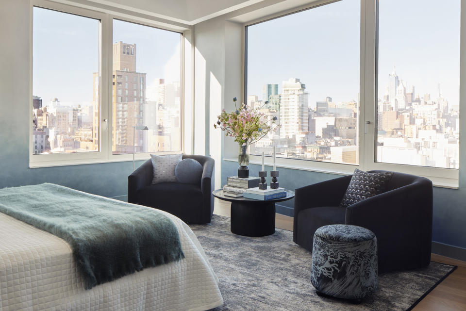 master bedroom with ombre walls and bed facing windows