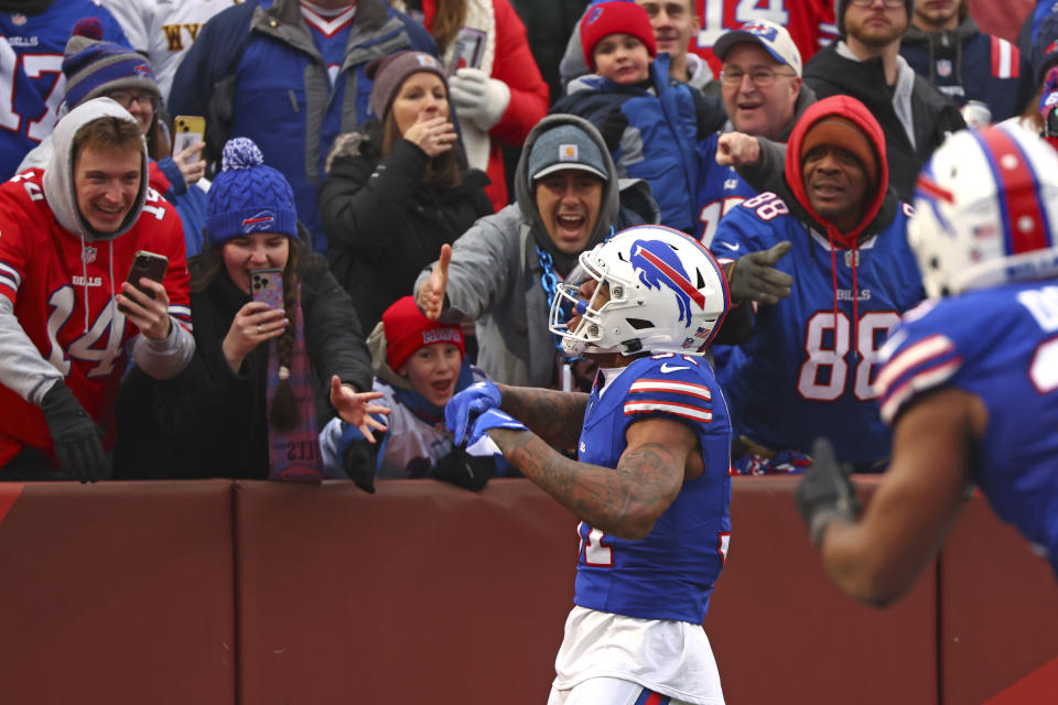 Buffalo Bills cornerback Rasul Douglas, center, celebrates with fans after returning an interception for a touchdown during the first half of an NFL football game against the New England Patriots in Orchard Park, N.Y., Sunday, Dec. 31, 2023. (AP Photo/Jeffrey T. Barnes )