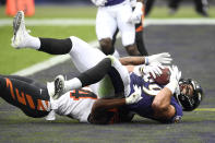 Baltimore Ravens tight end Mark Andrews, top, holds on to the ball while catching a touchdown pass from quarterback Lamar Jackson, not visible, as Cincinnati Bengals strong safety Vonn Bell (24) tries to defend during the first half of an NFL football game, Sunday, Oct. 11, 2020, in Baltimore. (AP Photo/Nick Wass)