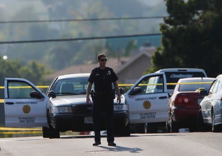 San Diego police officers investigate near the scene where an officer was fatally shot and another was injured at a traffic stop late on Thursday, in San Diego, California, U.S., July 29, 2016. REUTERS/Mike Blake