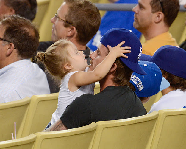 <br>Little Harper styling up her dad in his flat cap...