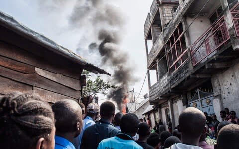 A small aircraft carrying around 15 passengers on Sunday crashed into a densely populated area of Goma - Credit: PAMELA TULIZO/AFP