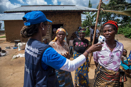 Dr. Marie-Roseline Darnycka Bélizaire, World Health Organisation (WHO) Epidemiology Team Lead, talks to women as part of Ebola contact tracing, in Mangina, Democratic Republic of Congo August 26, 2018. WHO/Junior Kannah/Handout via REUTERS/File Photo