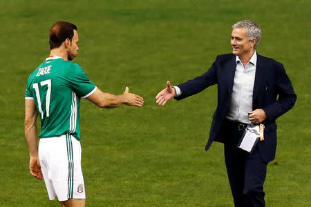 Former Chelsea manager Jose Mourinho shakes hands with Luis Roberto Alves of Mexico during a friendly soccer match between FIFA Football Legends against Mexican all-stars as part of the 66th FIFA Congress and 50th anniversary of the Azteca stadium, at Azteca stadium in Mexico City, Mexico, May 11, 2016. REUTERS/Edgard Garrido