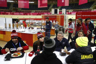 <p>International Olympic Committee President Thomas Bach, second from right, visits with members of the Canadian and Jamaican Olympic teams as they eat lunch during a tour of the PyeongChang Olympic Village. (AP) </p>