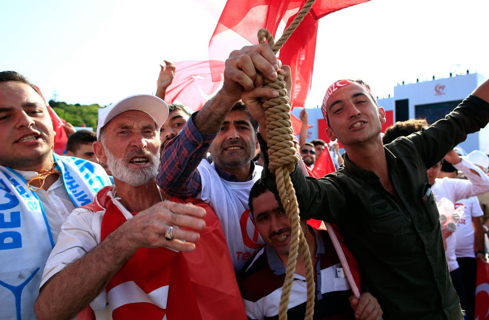 <p>People pose with a hangman’s knot as they take part in the “National Unity March” to commemorate the one year anniversary of the July 15, 2016 botched coup attempt, in Istanbul, Saturday, July 15, 2017. (Photo: Lefteris Pitarakis/AP) </p>