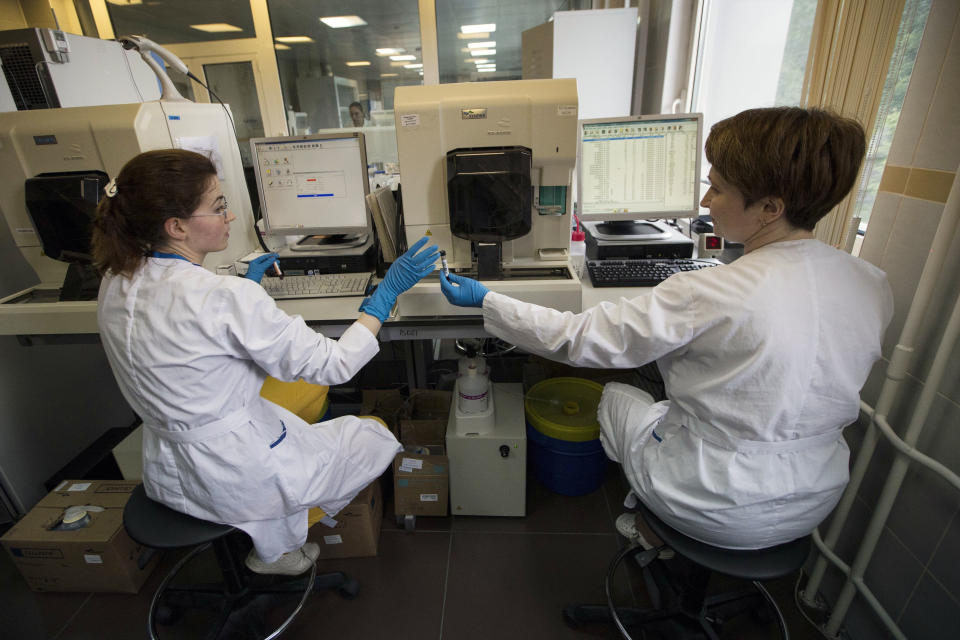 FILE - In this May 24, 2016 file photo employees work in Russia's national drug-testing laboratory in Moscow. For the Sochi Games in 2014, Russian medal contenders handed over samples of clean urine months in advance before taking a cocktail of steroids dissolved in alcohol, according to Grigory Rodchenkov, then the director of the drug-testing lab for the Games, who later fled to the United States. During the Olympics, Rodchenkov said he swapped out samples via a hole in the wall of the laboratory to a person from the Russian security services who opened the urine sample bottles and replaced the contents with the stored, clean urine. (AP Photo/Alexander Zemlianichenko, File)
