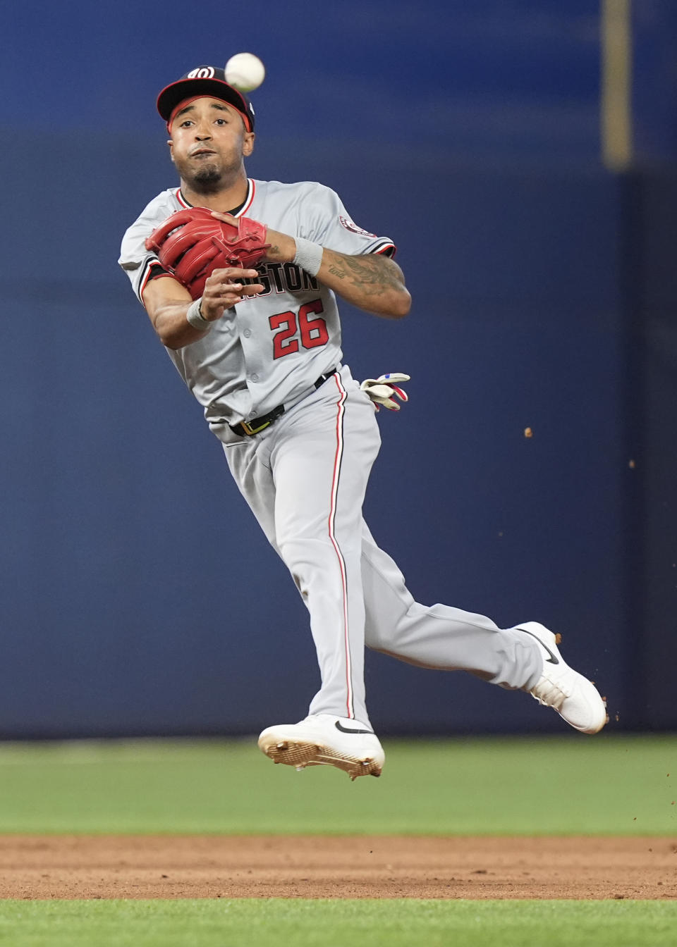 Washington Nationals shortstop Nasim Nunez (26) throws to first base for an out during the eighth inning of a baseball game against the Miami Marlins, Saturday, April 27, 2024, in Miami. (AP Photo/Marta Lavandier)