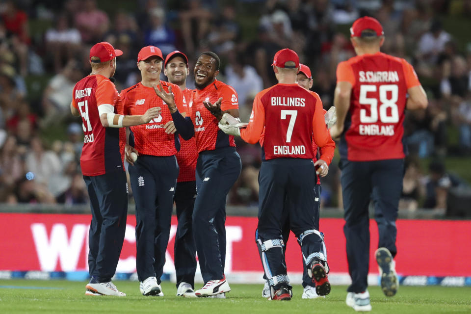 England's Chris Jordan, center, and teammates celebrate the wicket of new Zealand's Tim Seifert during the T20 cricket match between England and New Zealand in Napier, New Zealand, Friday, Nov. 8, 2019. (John Cowpland/Photosport via AP)