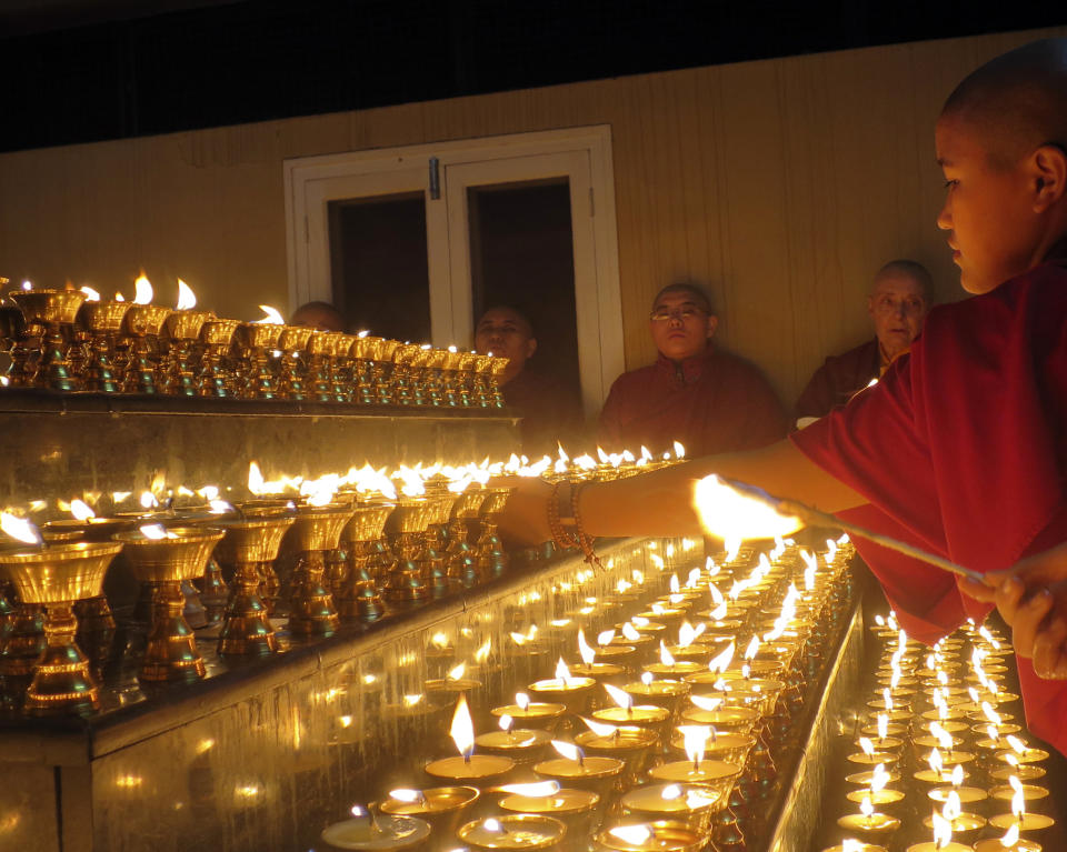 In this photo provided by the Dongyu Gatsal Ling nunnery, Buddhist nuns offer hundreds of butter lamps, which symbolizes the wisdom aspect dispelling the darkness of ignorance, at the nunnery in the state of Himachal Pradesh, India on Nov. 8, 2016. About 100 nuns live and study here. (Dongyu Gatsal Ling nunnery via AP)