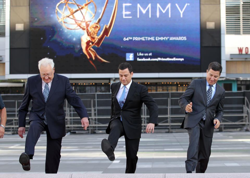  Don Mischer, executive producer of the 64th Primetime Emmy Awards, left, host Jimmy Kimmel, center, and Television Academy chairman and chief executive Bruce Rosenblum attend the Emmy Awards Red Carpet Rollout at the Nokia Theatre on Wednesday, Sept. 19, 2012, in Los Angeles. The Emmy Awards will be held Sunday, Sept 23. (Photo by Matt Sayles/Invision/AP)