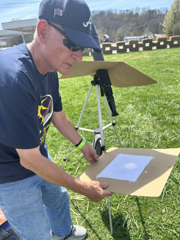 Jim Hutchinson projects an image of the sun onto a cardboard screen at Hoosier Fest in Nashville, Ind. (GeekWire Photo / Alan Boyle)