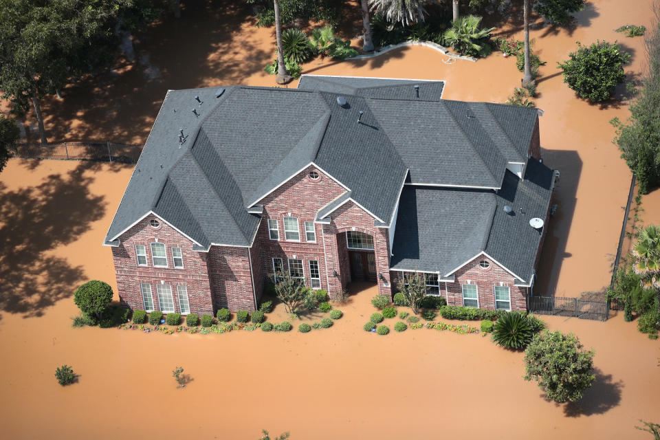 A home is surrounded by floodwater after torrential rains pounded Southeast Texas.