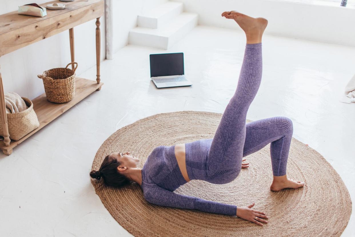 Woman performing a single leg glute bridge