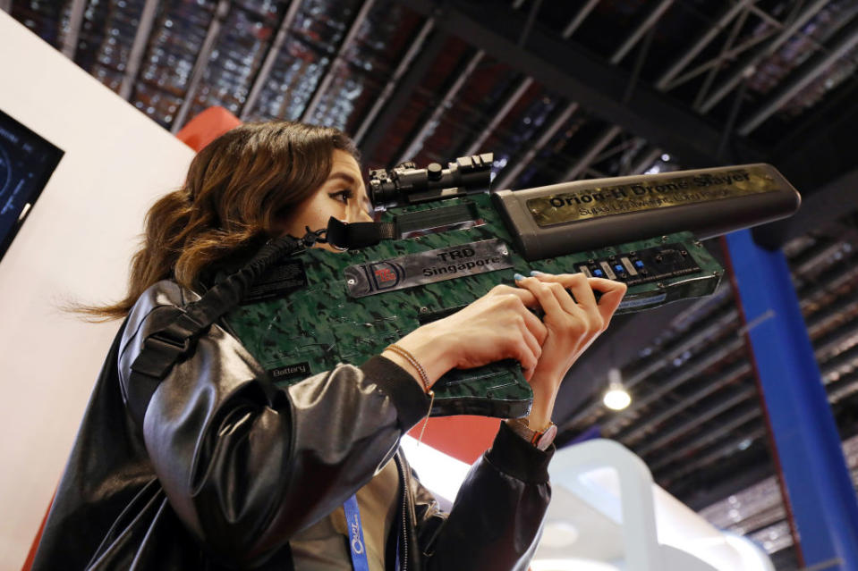 An attendee tries out a TRD Orion-H Drone Slayer at the Singapore Airshow in Singapore, on Wednesday, Feb. 7, 2018.<span class="copyright">SeongJoon Cho—Bloomberg/Getty Images</span>