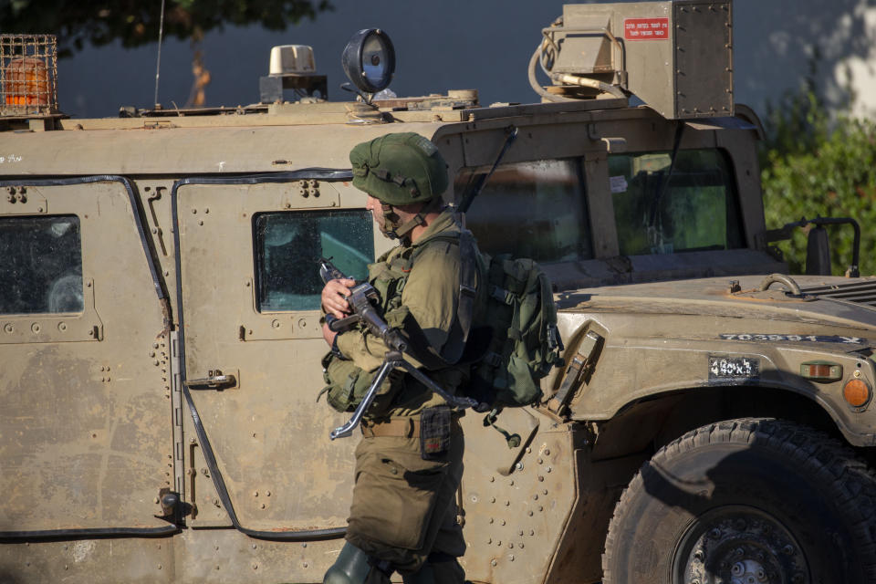 An Israeli soldier secures the village of Avivim on the Israel-Lebanon border, Monday, Sept. 2, 2019. Hezbollah militants on Sunday fired a barrage of anti-tank missiles into Israel, prompting a reprisal of heavy Israeli artillery fire in a rare burst of fighting between the bitter enemies. (AP Photo/Ariel Schalit)