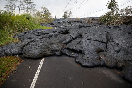 Lava covers Pohoiki Road near Pahoa, Hawaii, U.S., May 29, 2018. REUTERS/Marco Garcia