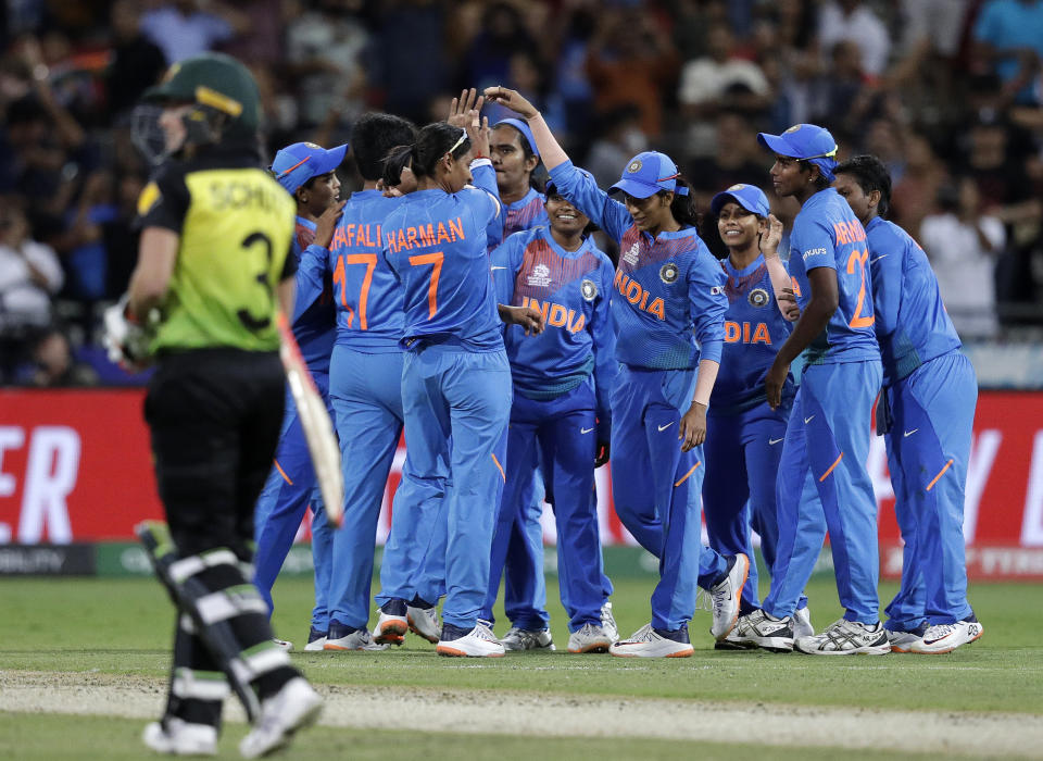 The Indian team celebrate their win over Australia in the first game of the Women's T20 Cricket World Cup in Sydney, Friday, Feb. 21, 2020. (AP Photo/Rick Rycroft)