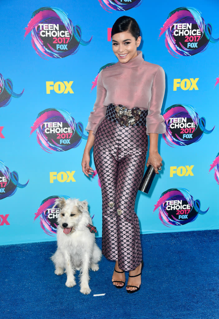 <p>The queen of Coachella has the best accessory of the night! Hudgens paired her high-waist pants and sheer top with a dog named Happy. (Photo: Getty Images) </p>