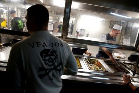 A US Navy sailor queues for food on board the USS Harry S. Truman aircraft carrier in the eastern Mediterranean Sea, June 14, 2016. REUTERS/Baz Ratner