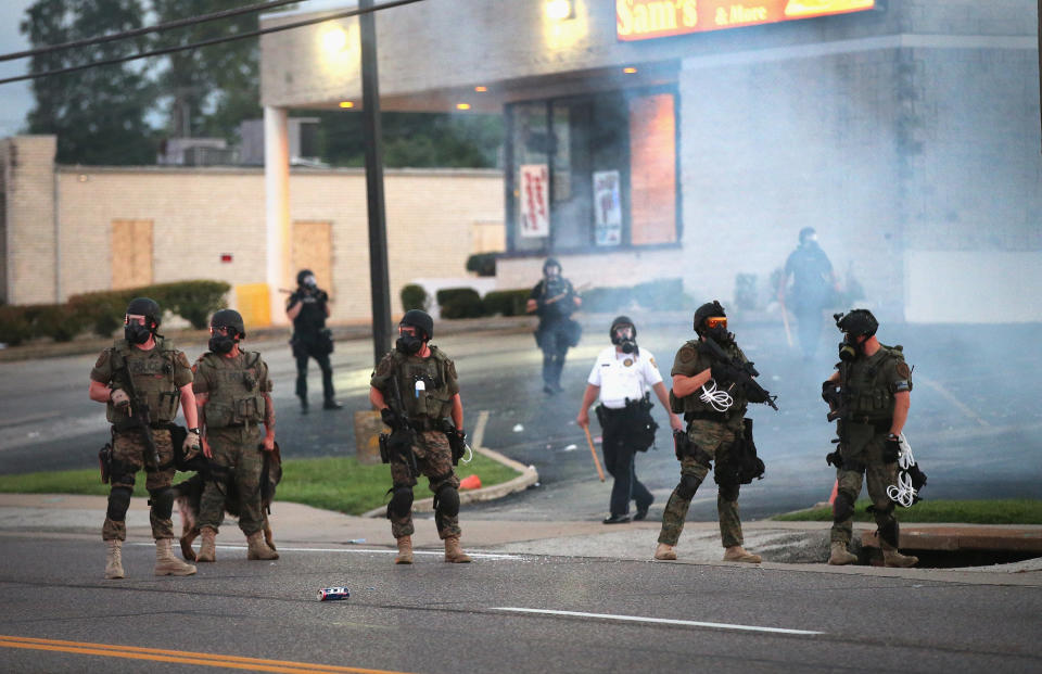 Tear gas hangs in the air as police force protesters from the business district on Aug. 11, 2014.