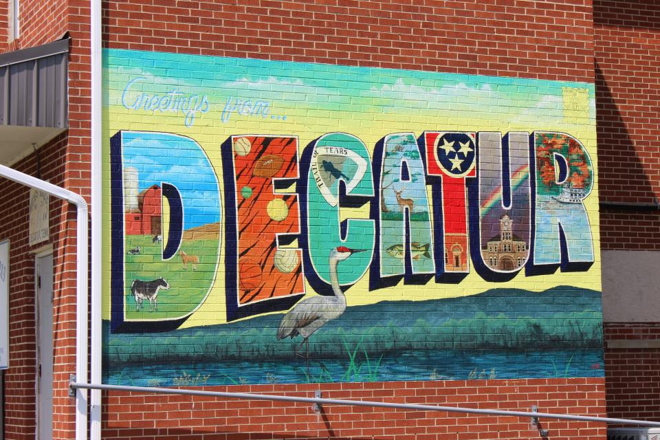 A mural welcomes visitors to Decatur, a town in Meigs County, Tennessee. Meigs County reported the highest covid-19 vaccination rate in the state for most of the past year, but the rate was inflated because of a data error.