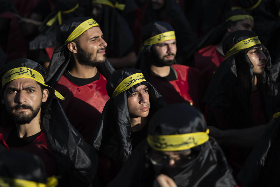 Hezbollah supporters in a sermon listen to the story of Ashoura, the Shiite Muslim commemoration marking the death of Imam Hussein, the grandson of the Prophet Muhammad, at the Battle of Karbala in present-day Iraq in the 7th century, in the southern suburbs of Beirut, Lebanon, Saturday, July 29, 2023. The leader of Lebanon's Hezbollah militant group said Saturday that if the governments of Muslim-majority nations do not take action against countries that allow the desecration of the Quran, it is the responsibility of Muslims to "punish" those who facilitate attacks on the Islamic holy book. (AP Photo/Hassan Ammar)