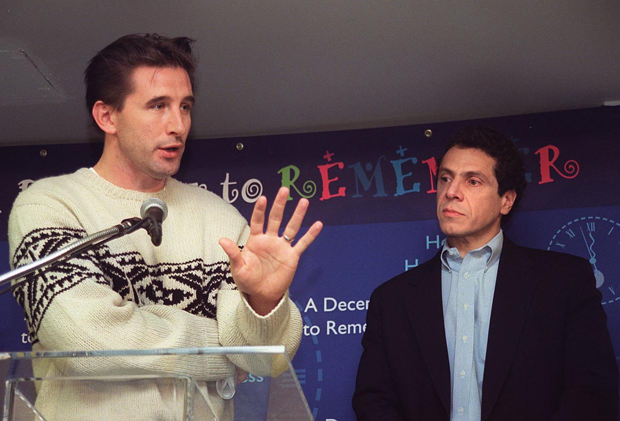 Actor and president of the Creative Coalition William Baldwin, left, speaks to reporters as US Housing and Urban Development Secretary (HUD) Andrew Cuomo, right,  looks on during a press conference in Dec. 1999 at The House of Ruth, a transitional housing facility for homeless families in Washington, DC .