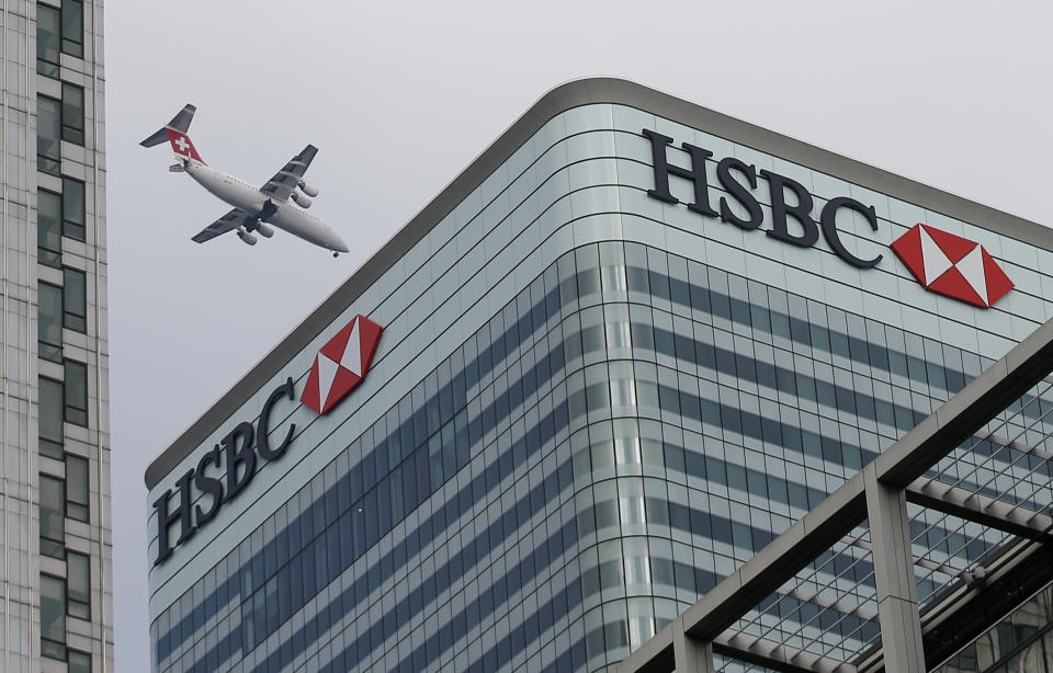 A Swiss International aircraft flies past the HSBC headquarters building in the Canary Wharf financial district in east London February 15, 2015. HSBC apologised to customers and investors on Sunday for past practices at its Swiss private bank after allegations that it helped hundreds of clients to dodge taxes. REUTERS/Peter Nicholls (BRITAIN - Tags: BUSINESS CRIME LAW TRANSPORT TPX IMAGES OF THE DAY)