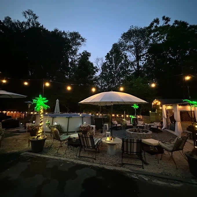 Reviewer's photo of the bistro lights strung up and illuminating a patio at night