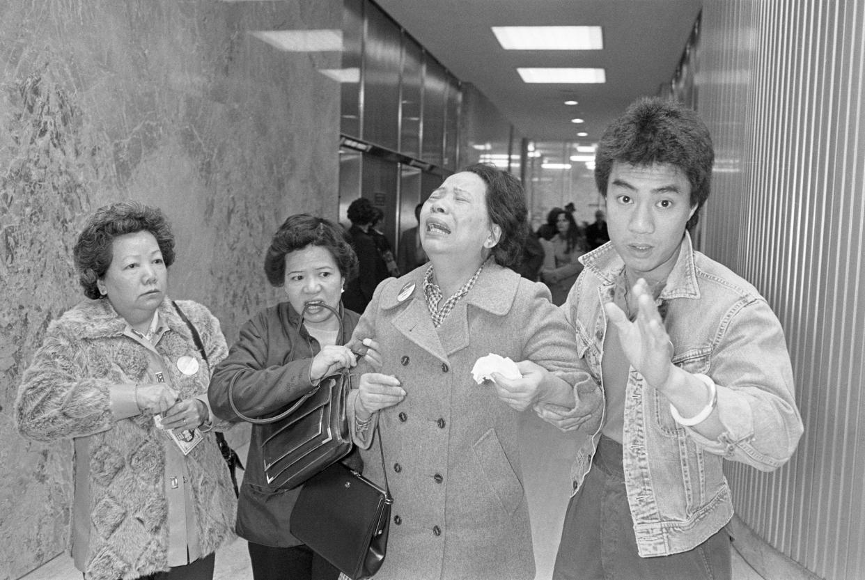 Lillie Chin, mother of Vincent chin who was clubbed to death by two white men in June 1982, breaks down as a relative (L), helps her walk while leaving Detroit's City County Building. Mrs. Chin along with the American Citizens for Justice are asking Judge Charles Kaufman, who heard the case and passed sentence, to resentence the two involved in the slayings. Kaufman sentenced the men to 3 years probation after plea bargaining agreements.