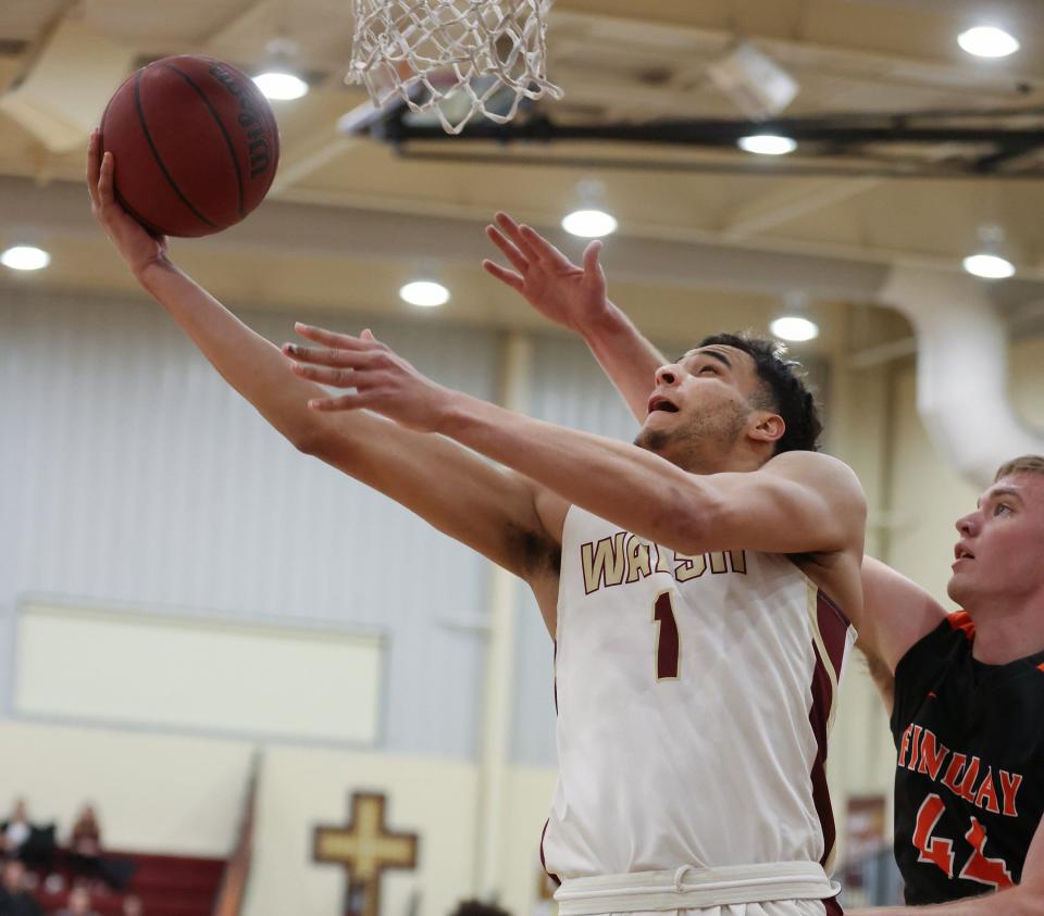 Walsh’s Tim Smith Jr. drives past Findlay’s Josh Thorbahn  in a G-MAC Tournament semifinal, Friday, March 4, 2022.