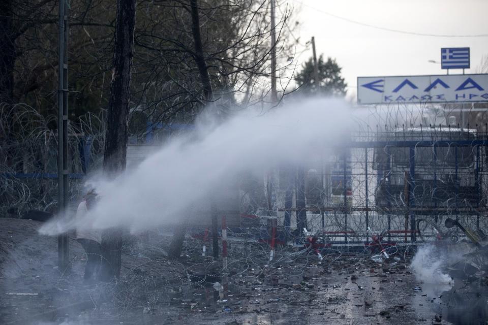 A Greek police water cannon operates from Kastanies border gate as migrants try to enter Greece from the Pazarkule border gate, Turkey at the Turkish-Greek border on Friday, March 6, 2020. Clashes erupted anew on the Greek-Turkish border Friday as migrants attempted to push through into Greece, while the European Union's foreign ministers held an emergency meeting to discuss the situation on the border and in Syria, where Turkish troops are fighting. (AP Photo)