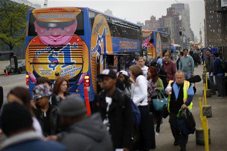 Passengers line up to board Megabus buses in New York City May 8, 2014. REUTERS/Eduardo Munoz