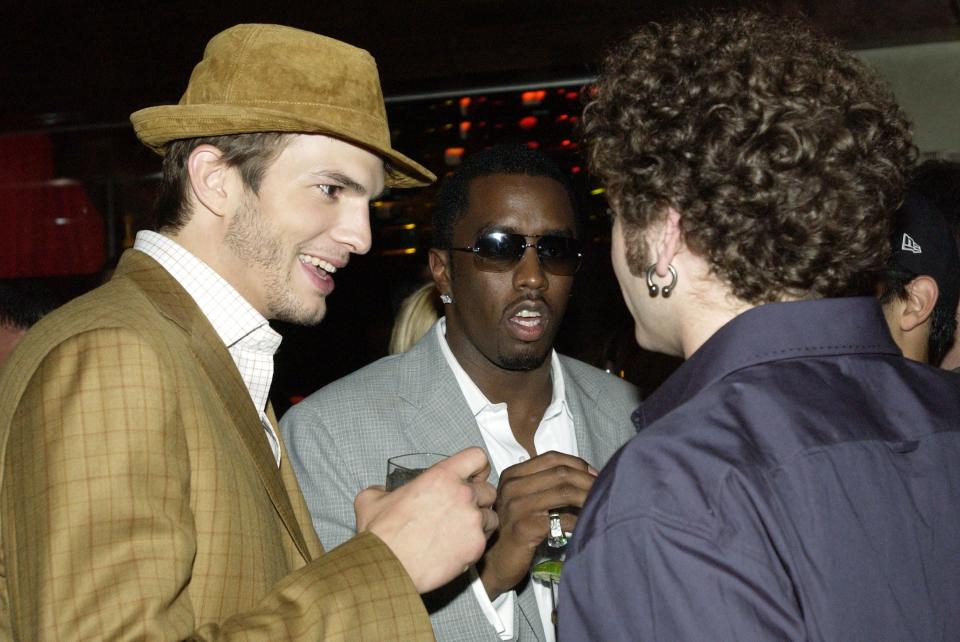 Ashton Kutcher talking to Puff Daddy and Danny Masterson at Dolce