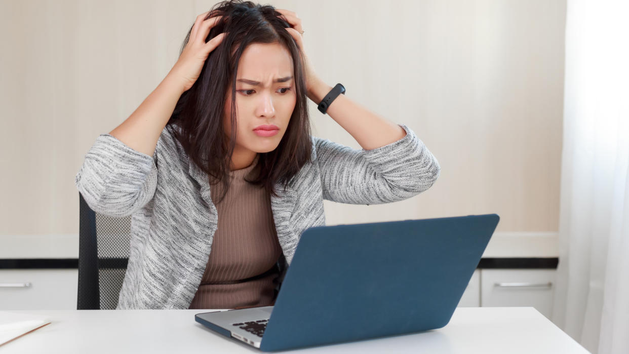  Angry woman using a laptop. 