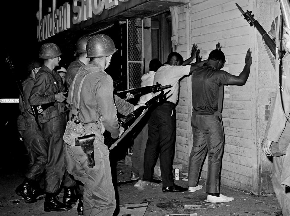 National Guardsmen pointed bayonets at three men arrested during  July 1967 riots in Newark. (John Duricka / AP file)