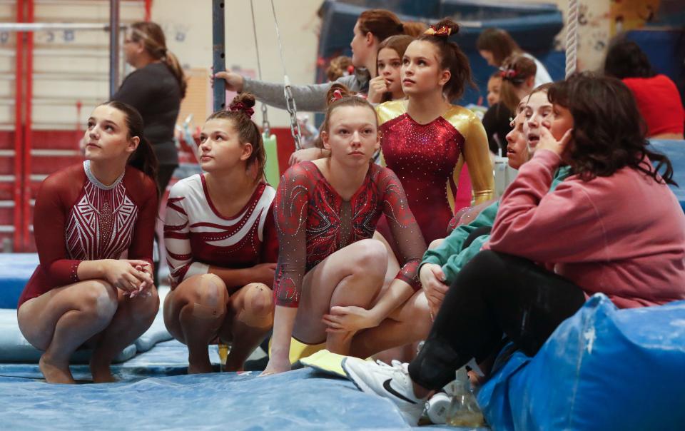 Athletes watch each other compete during the IHSAA gymnastics invitational, Wednesday, Jan. 17, 2024, at Linnwood Elementary School in Lafayette, Ind.