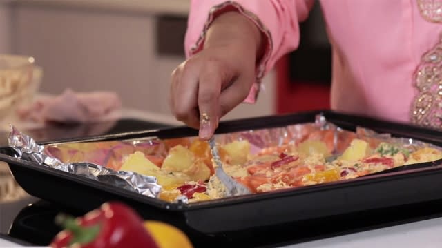 spread vegetables on baking tray lined with aluminium foil