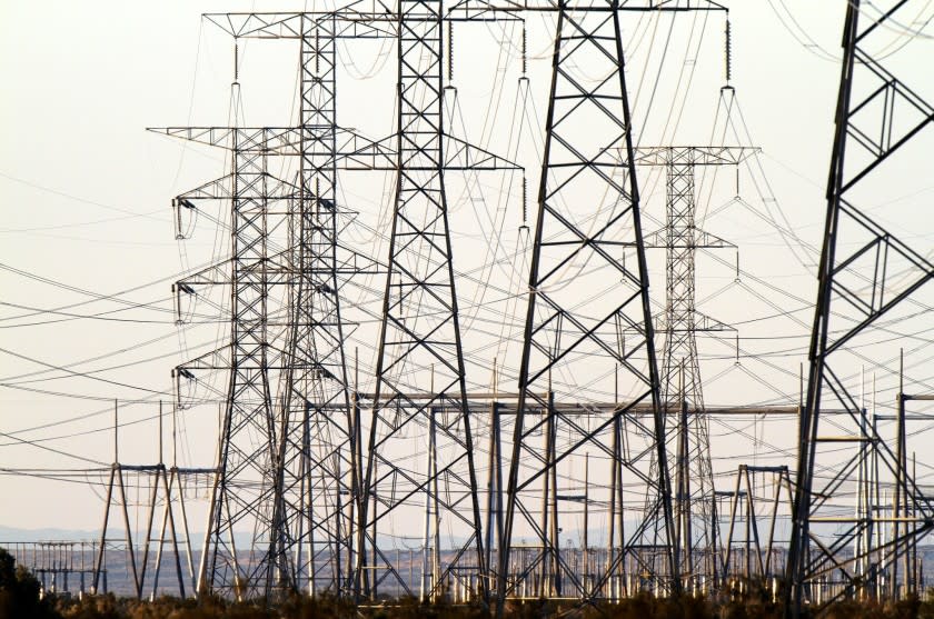 Rows of electricity transmission towers cross the Yuha Desert in western Imperial County. Additional lines are being constructed to deliver power from new solar-generation projects in nearby El Centro, Calif.